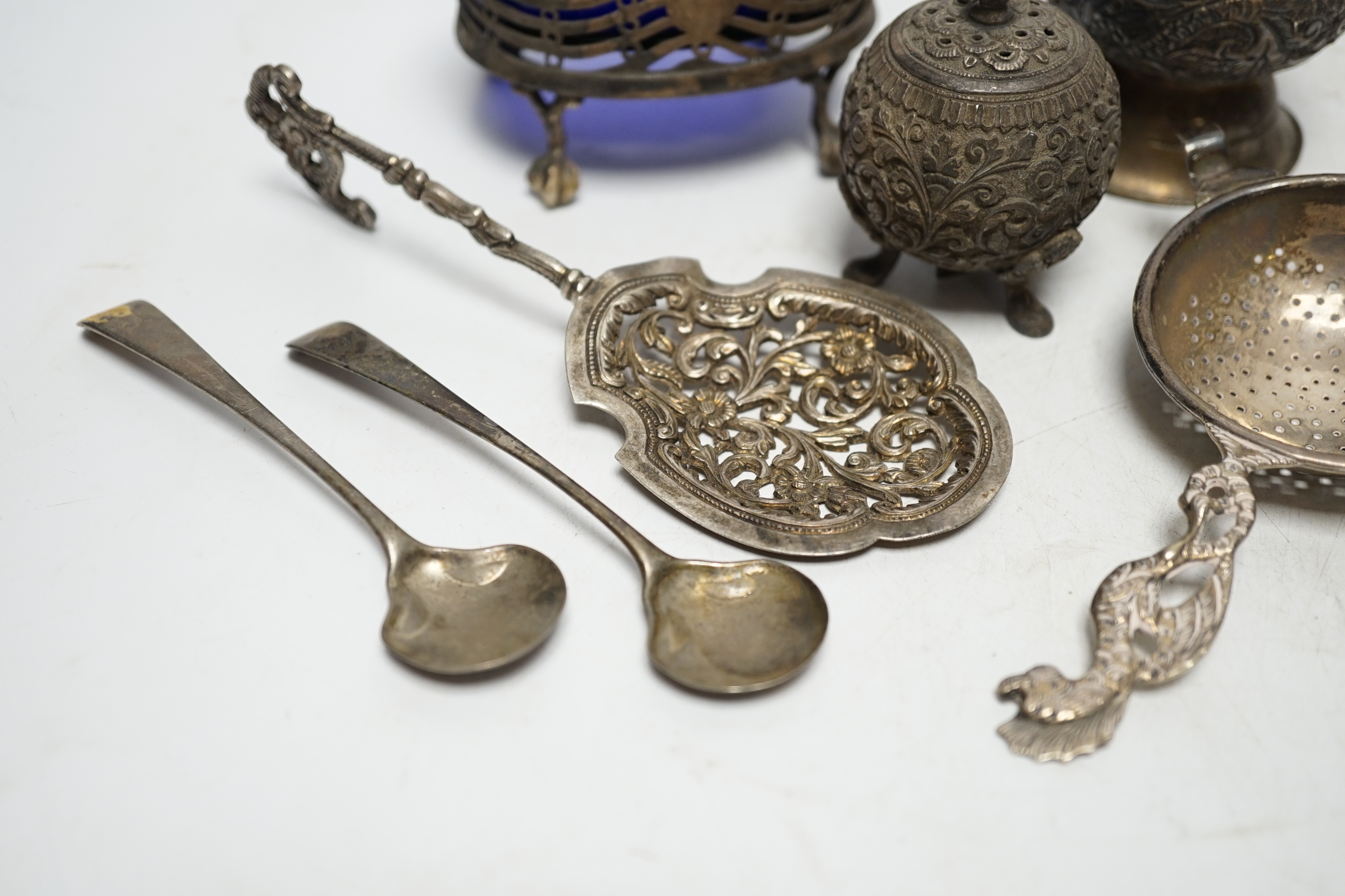 A group of small silver and white metal items including a George III oval salt, two Georgian condiment spoons, Indian condiment, etc. Condition- Fair.